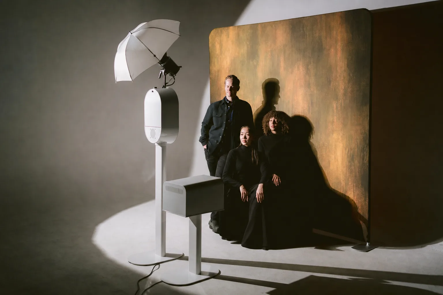 Colleagues posing in a studio setup with the booth